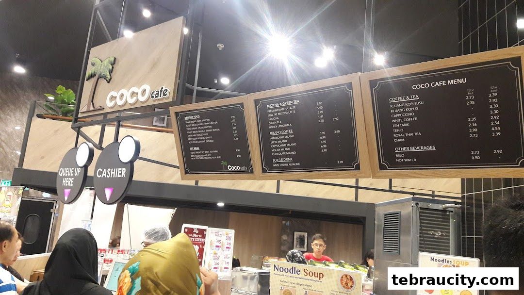 A view of the Coco Cafe menu boards displaying various drinks and food items.