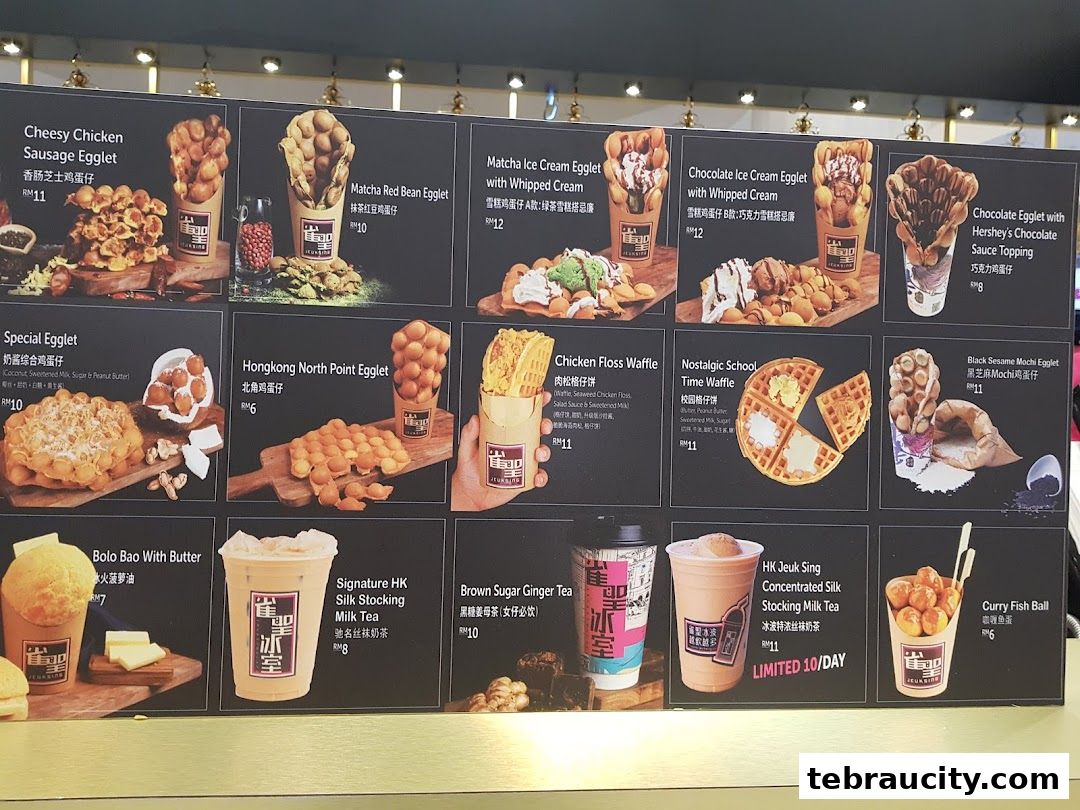 A menu board displaying various egglets, waffles, milk tea, and snacks with enticing images and prices.