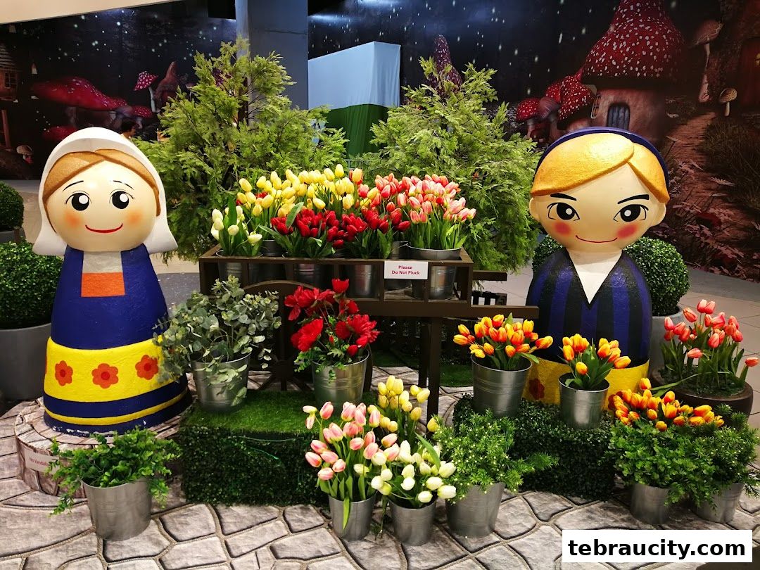 A whimsical display featuring cartoon figures and colorful tulips, evoking a fairytale garden.