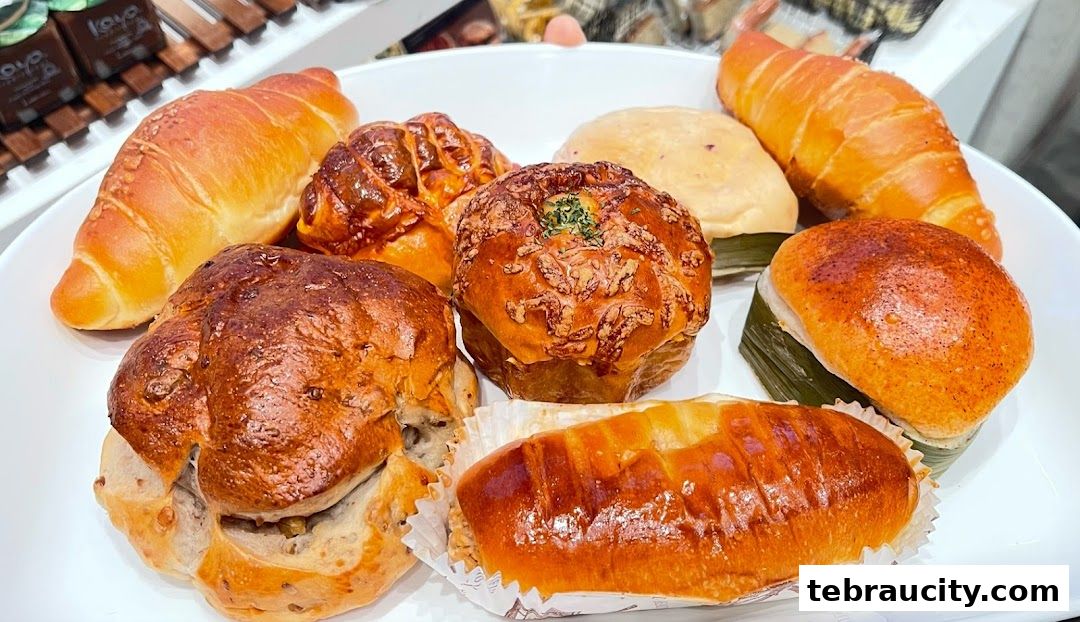 A white plate filled with a variety of freshly baked pastries and breads.