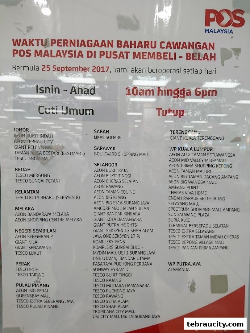 A sign displaying new operating hours for Pos Malaysia branches in shopping malls.