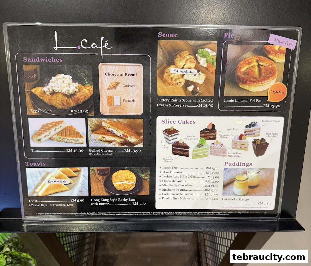 A menu board displaying various sandwiches, toasts, scones, pies, cakes, and puddings from L.Café.