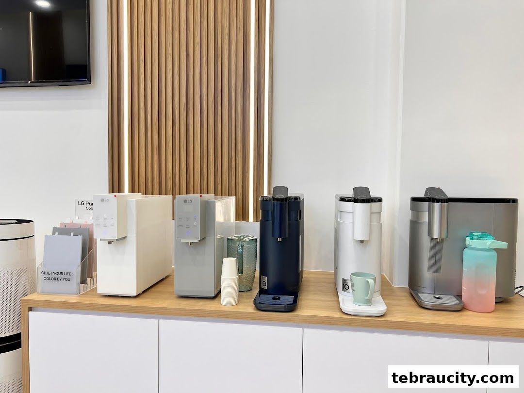 LG water purifiers and air purifiers displayed on a counter with cups and a water bottle.