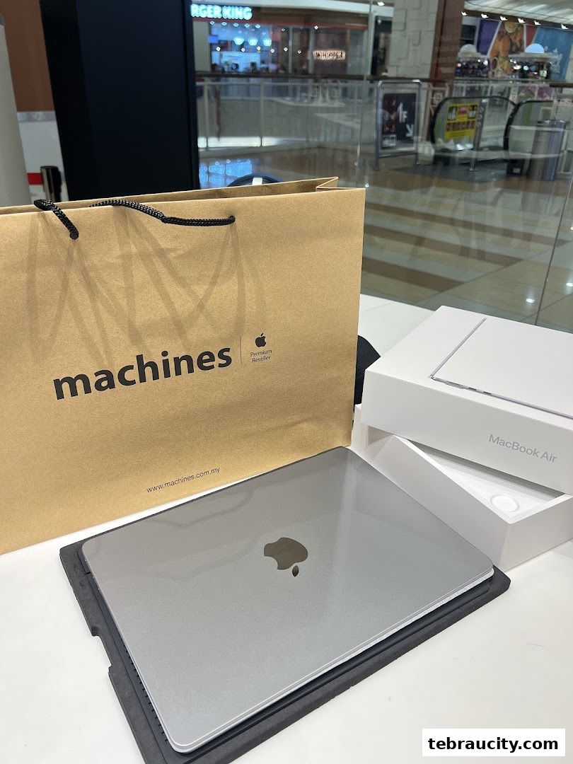 A MacBook Air and Machines branded shopping bag are displayed on a table.