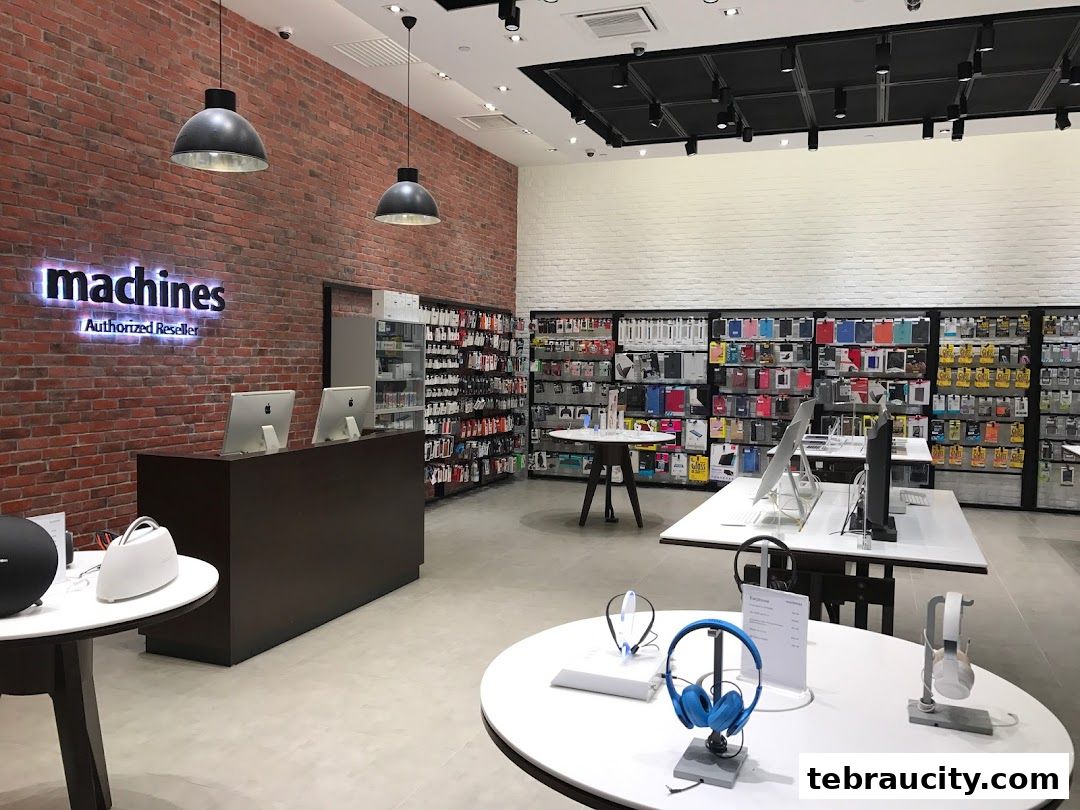 Interior of an Apple Reseller store with products displayed on tables and shelves.