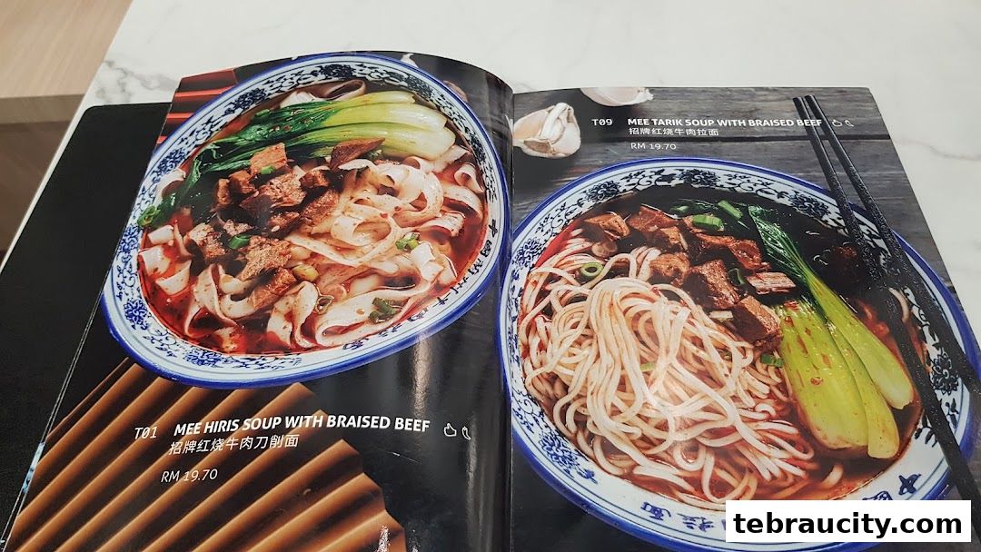 A menu showcasing two bowls of noodle soup with braised beef and vegetables.