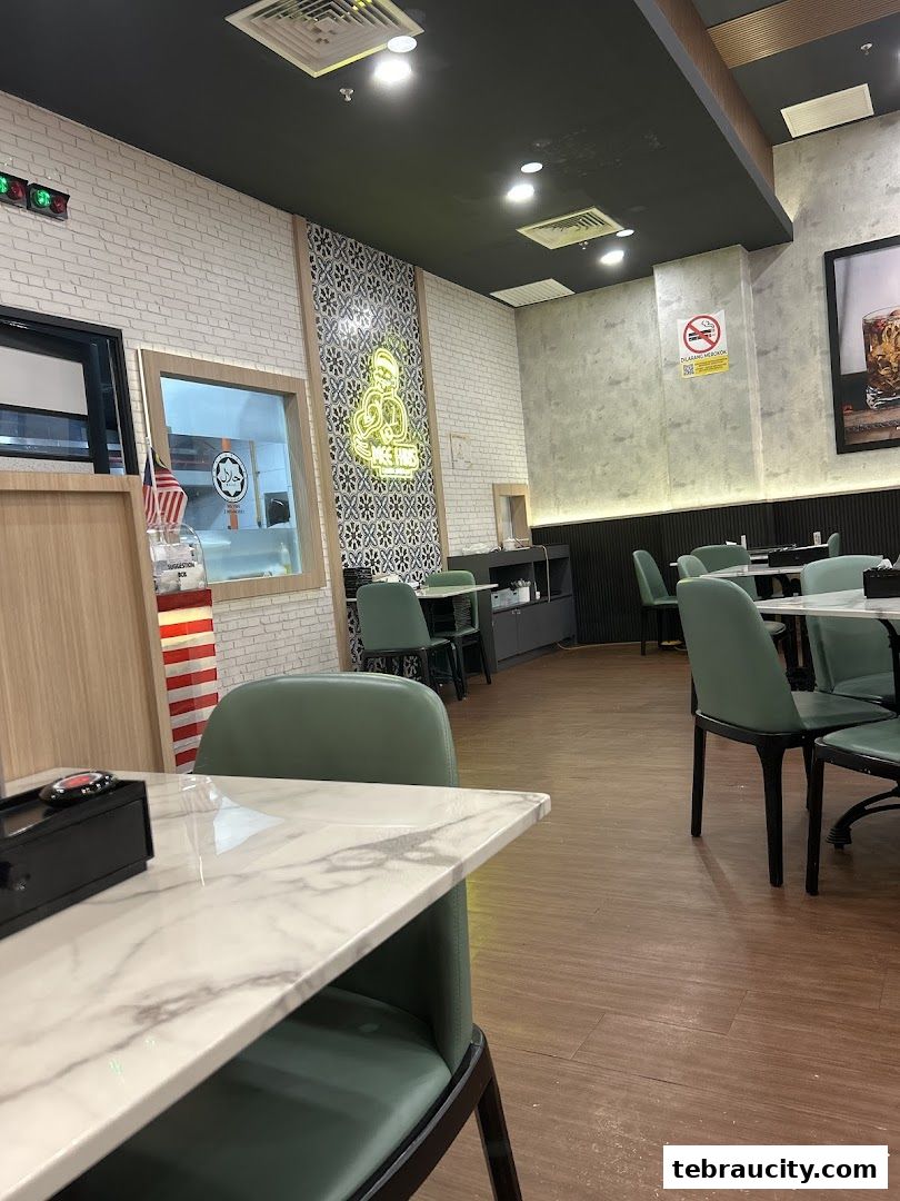 Interior view of Mee Hiris China Muslim restaurant with tables and chairs.