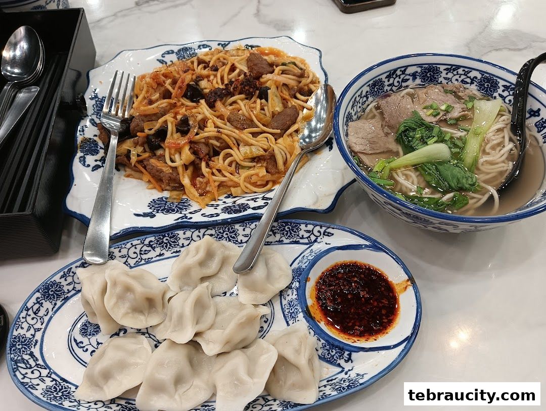 A table laden with delicious Chinese Muslim cuisine, featuring noodles, dumplings, and a hearty soup.