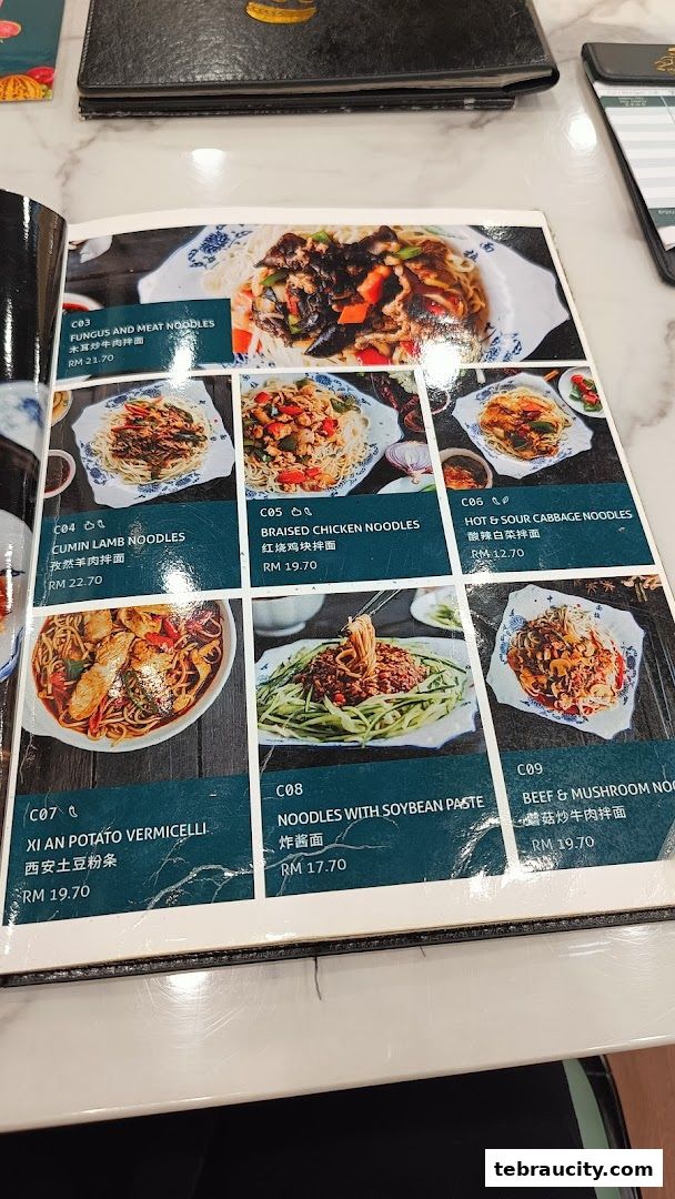 A menu from Mee Hiris China Muslim featuring various noodle dishes with prices.