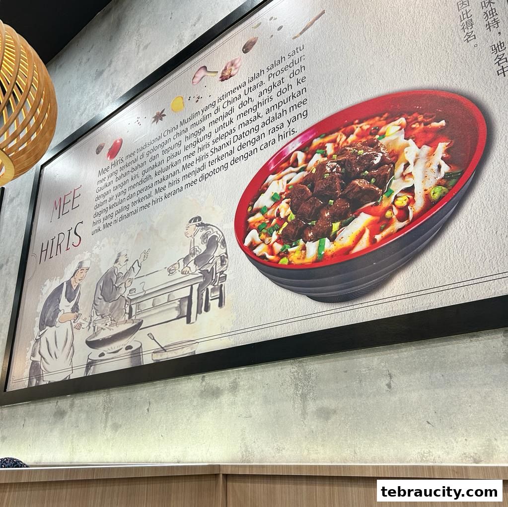 A wall display for Mee Hiris, featuring text and an image of a noodle dish.