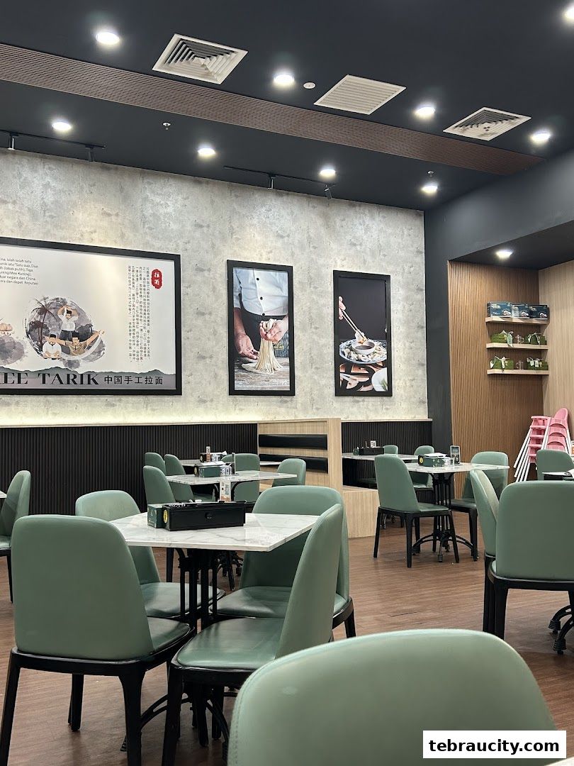 Interior view of a restaurant with tables, chairs, and decorative wall art.