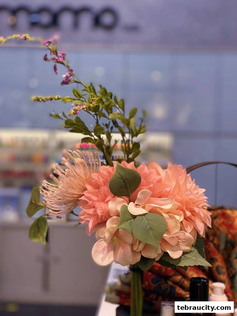 A close-up of a floral arrangement with the shop name 'Momo' blurred in the background.