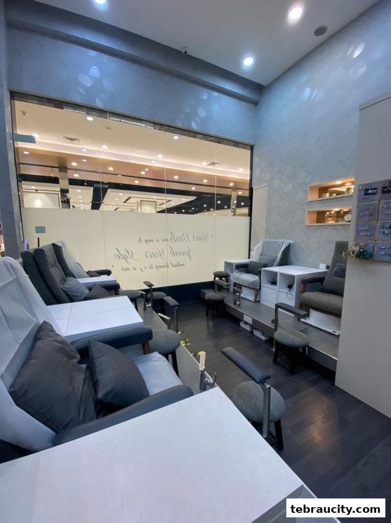 Interior view of a modern nail salon with multiple pedicure chairs and manicure stations.