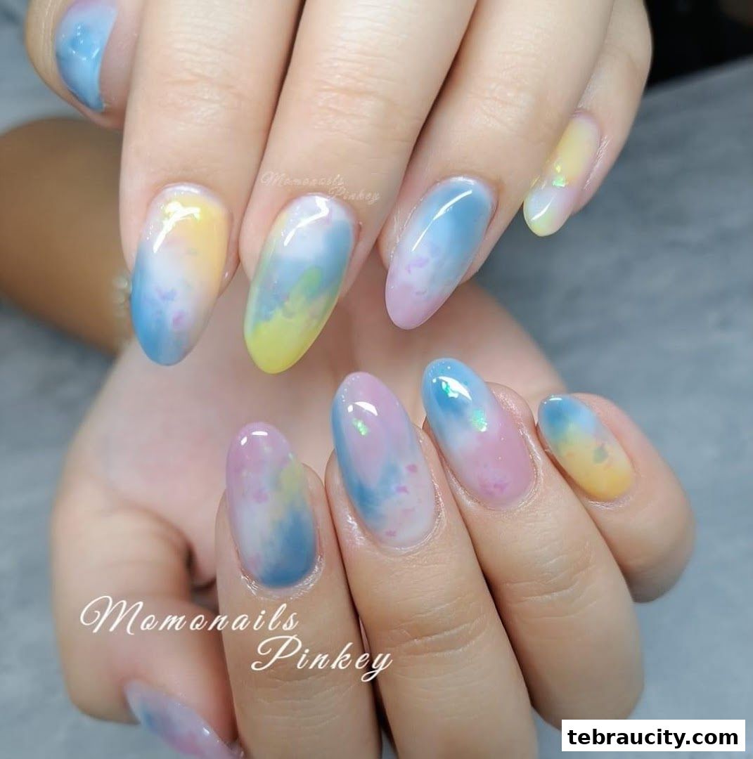 Close-up of hands with colorful watercolor-style nail art.