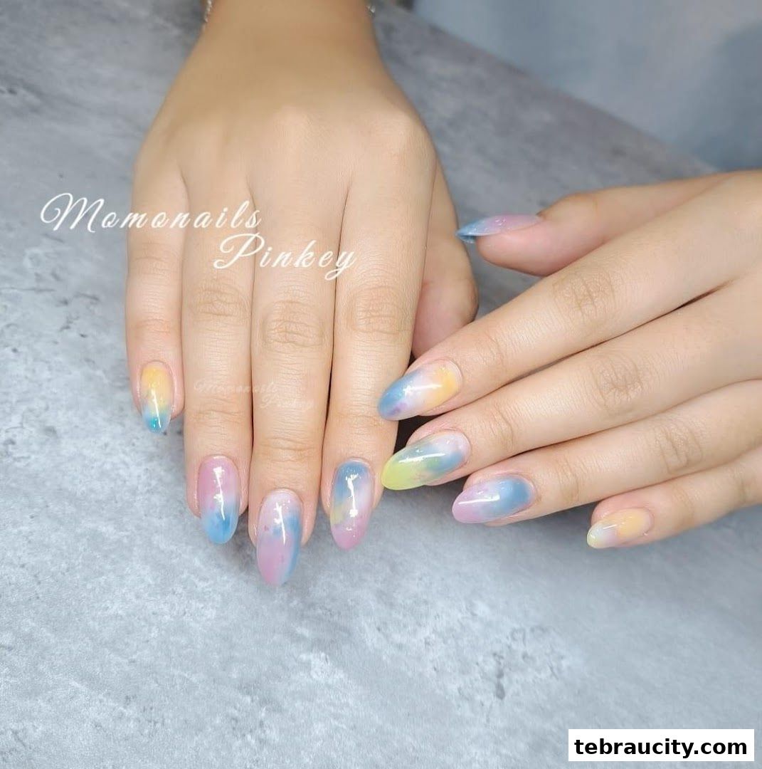 A close-up shot of a person's hands with beautifully designed ombre-style nails.