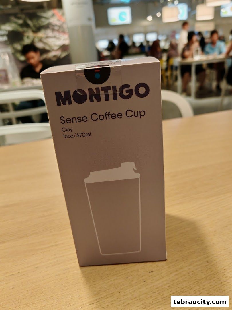 A Montigo Sense Coffee Cup product box displayed on a wooden table.