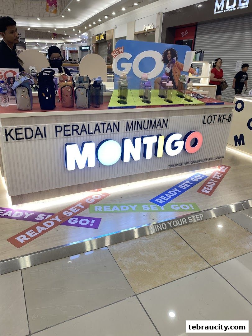 A Montigo store display featuring water bottles and accessories in a shopping mall.