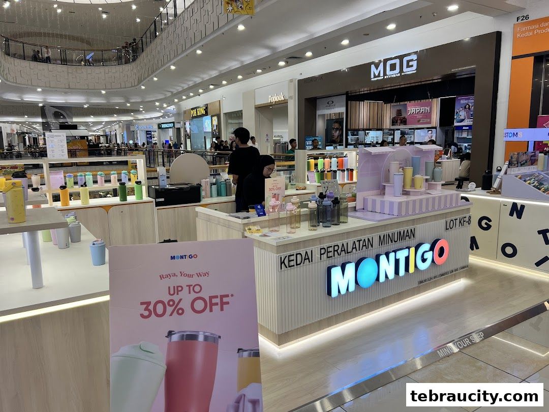 A Montigo store in a shopping mall, showcasing colorful drinkware and a promotional sign.
