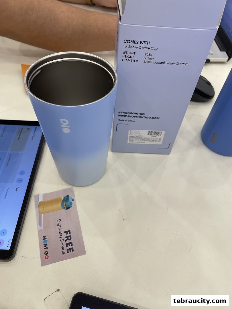 A light blue Montigo coffee cup and its packaging are displayed on a table.