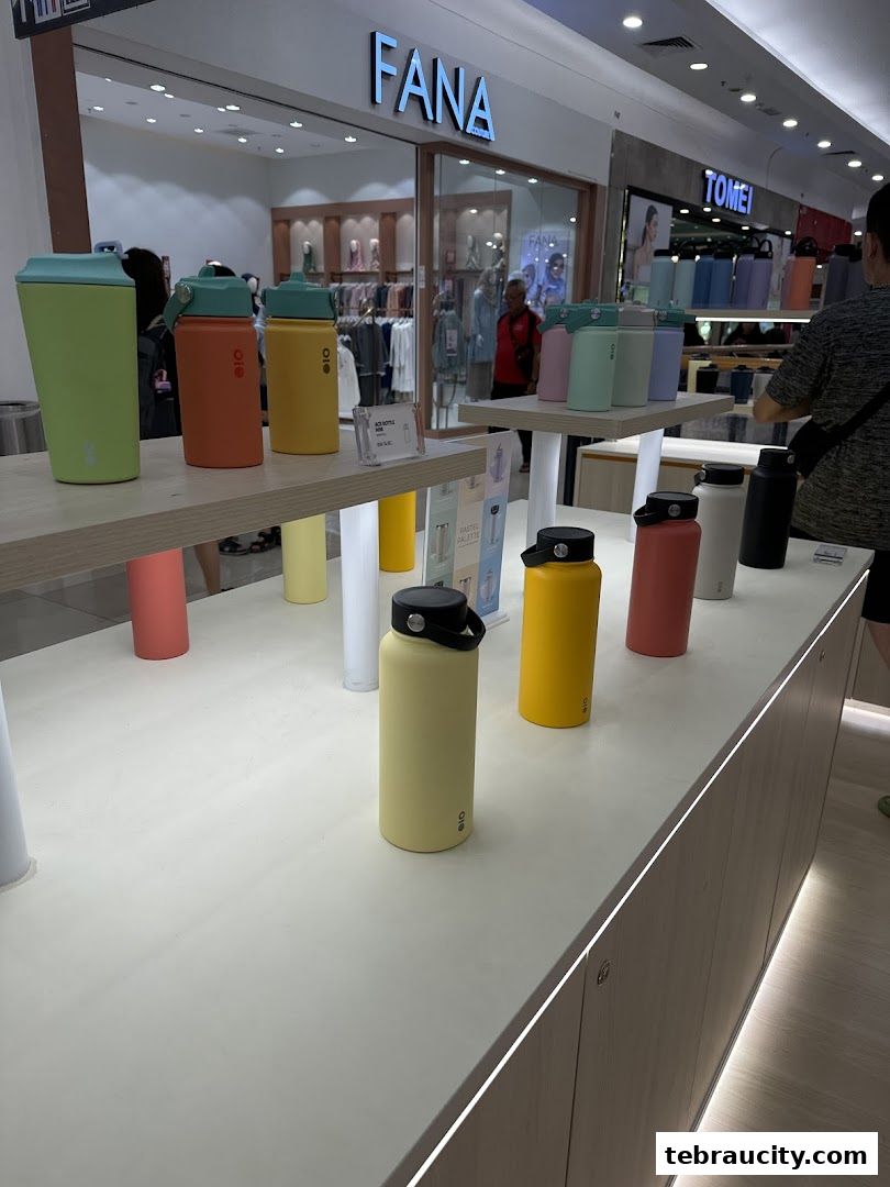 A display of colorful water bottles in a retail store.
