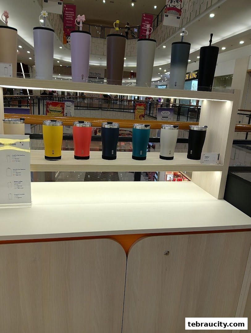 A display of colorful Montigo tumblers and bottles on shelves in a retail store.