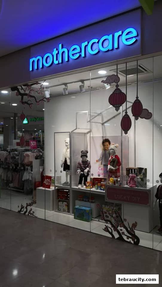 The Mothercare shop front displays children's clothing and mannequins in the window.