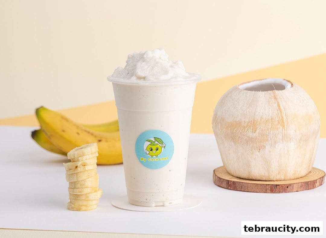 A creamy banana and coconut smoothie with fresh bananas and a whole coconut.