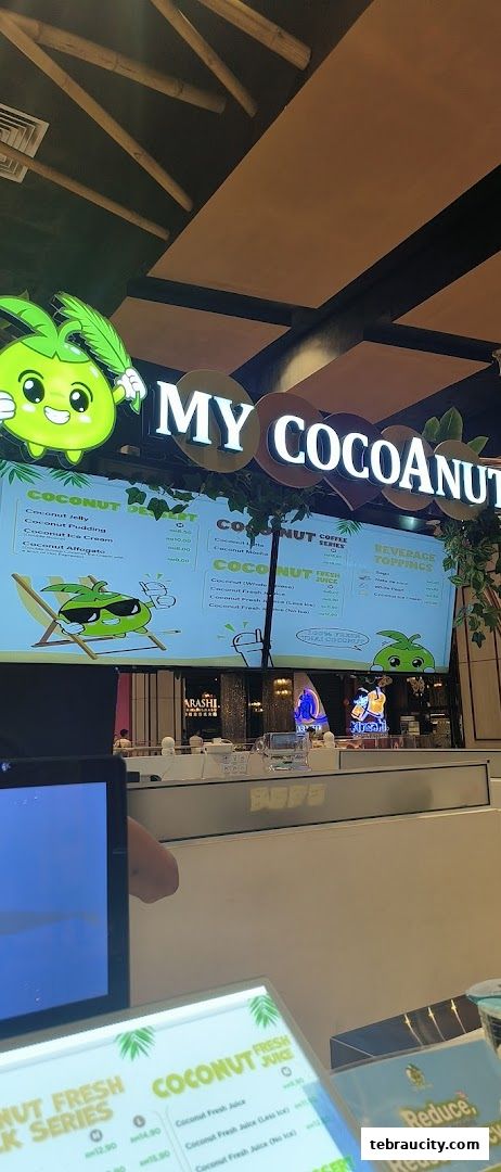 A brightly lit shop counter with a menu board displaying coconut-based drinks and desserts.