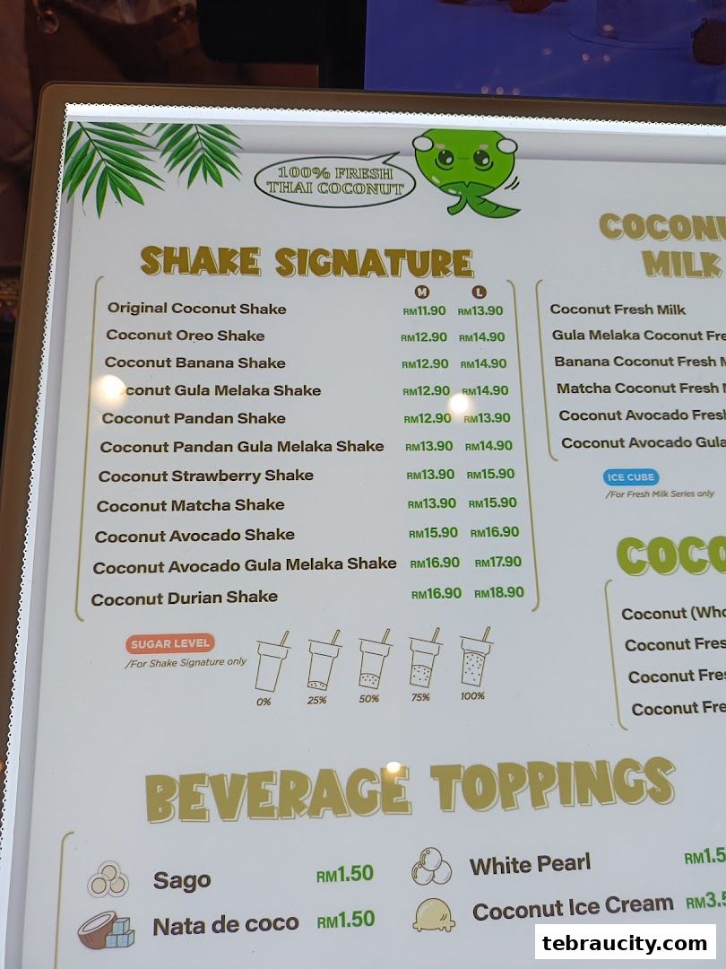 A menu board displaying various coconut shakes, milk drinks, and beverage toppings with prices.