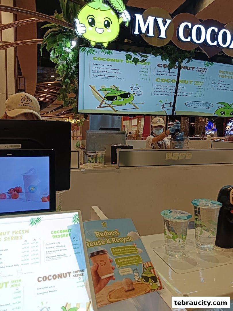 A menu board displaying various coconut-based drinks and desserts at My Cocoanut.