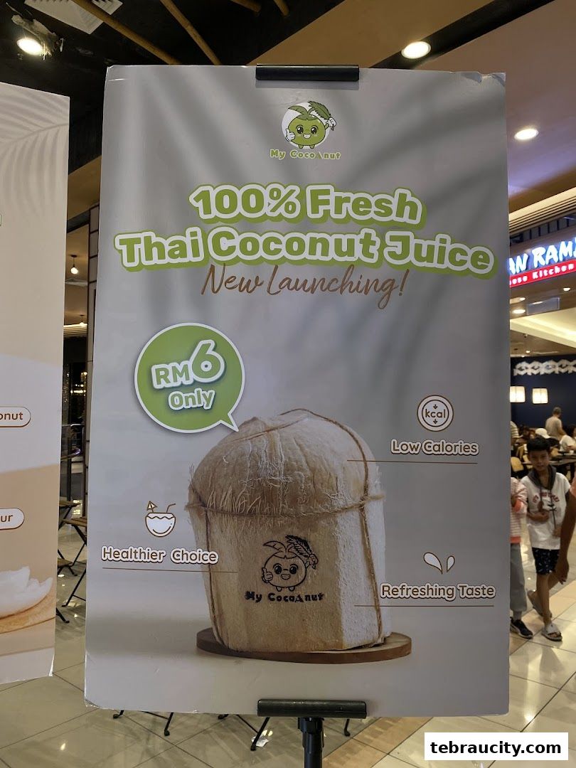 A promotional sign for My Cocoanut's 100% Fresh Thai Coconut Juice, highlighting its price and benefits.