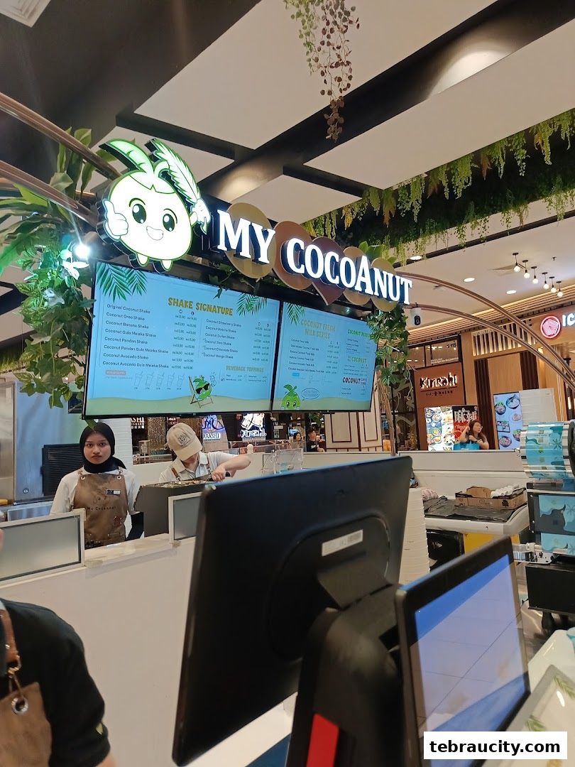 The My Cocoanut shop front with a menu board and staff serving customers.
