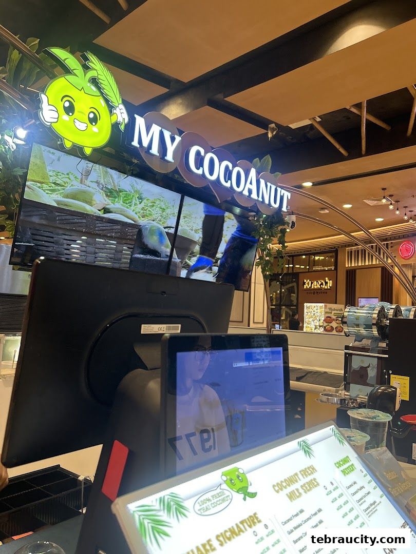 A counter display for My Cocoanut, featuring a menu and a screen showing coconuts.