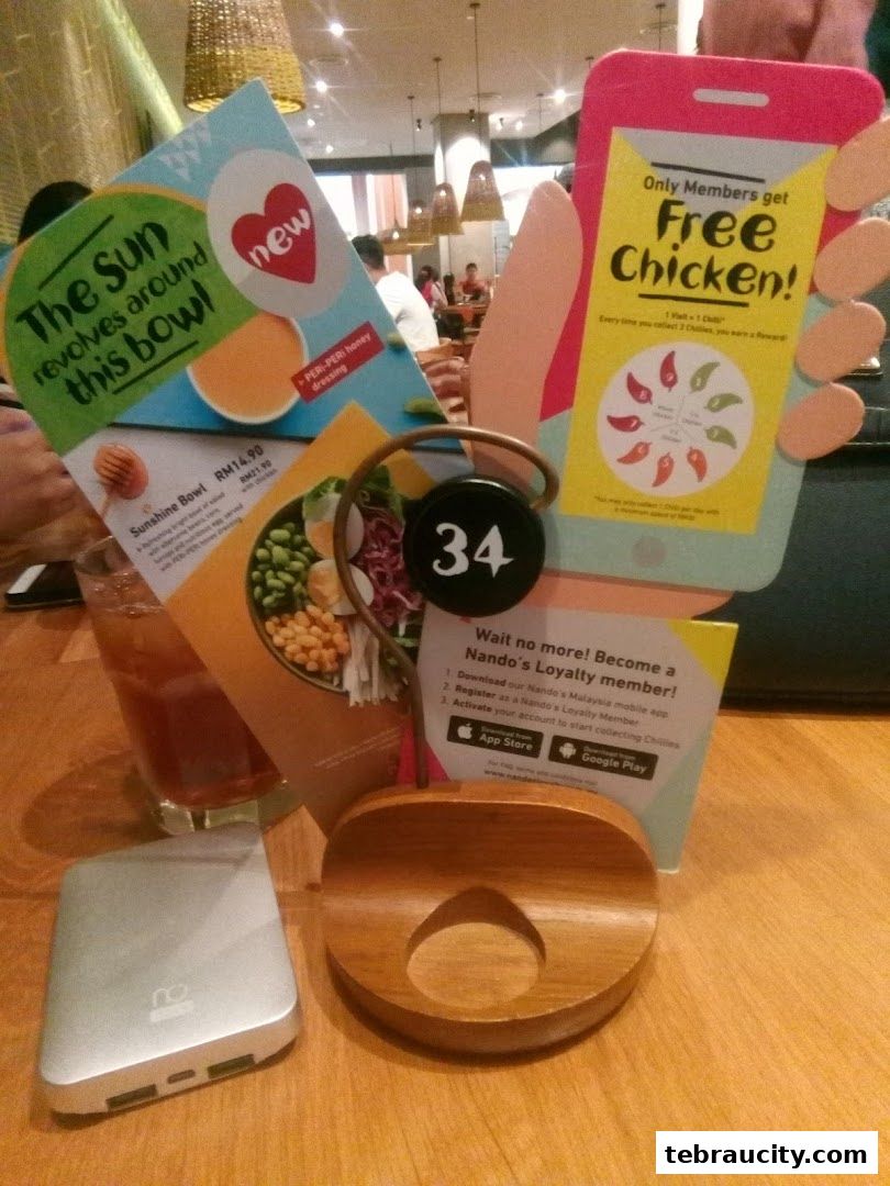 Table display at Nando's with promotional flyers and a table number.