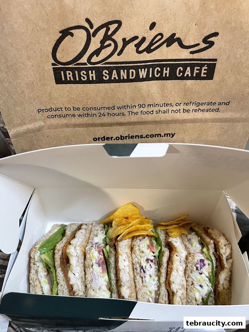 A box of O'Briens Irish Sandwich Cafe sandwiches with a branded paper bag.