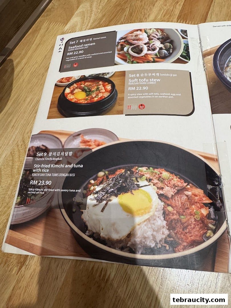 A menu from Oiso Korean Restaurant featuring seafood ramen, soft tofu stew, and stir-fried kimchi and tuna with rice.
