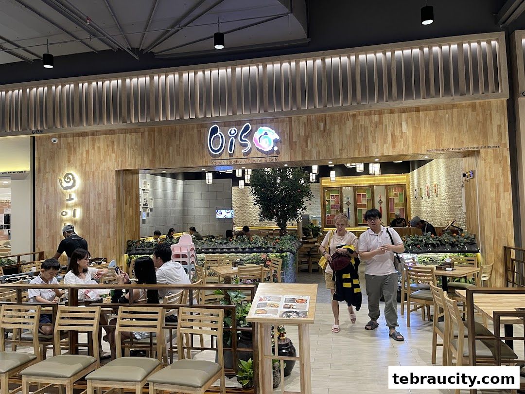 People entering a Korean restaurant with a warm, wooden interior and inviting ambiance.
