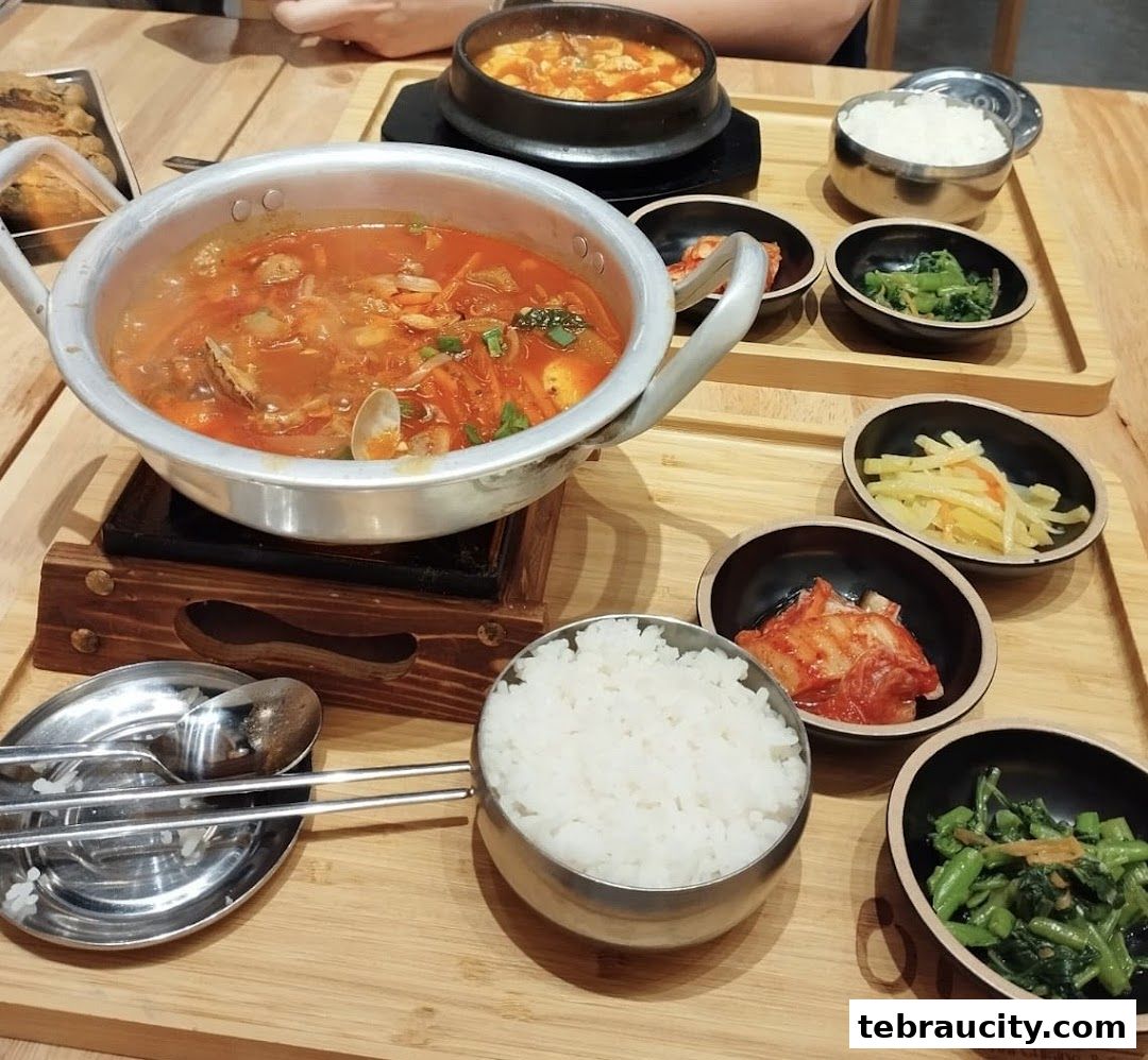 A delicious spread of Korean food, featuring a hearty stew, rice, and various side dishes.