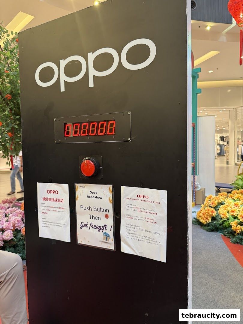 An OPPO countdown challenge event with a large screen, button, and promotional flyers.