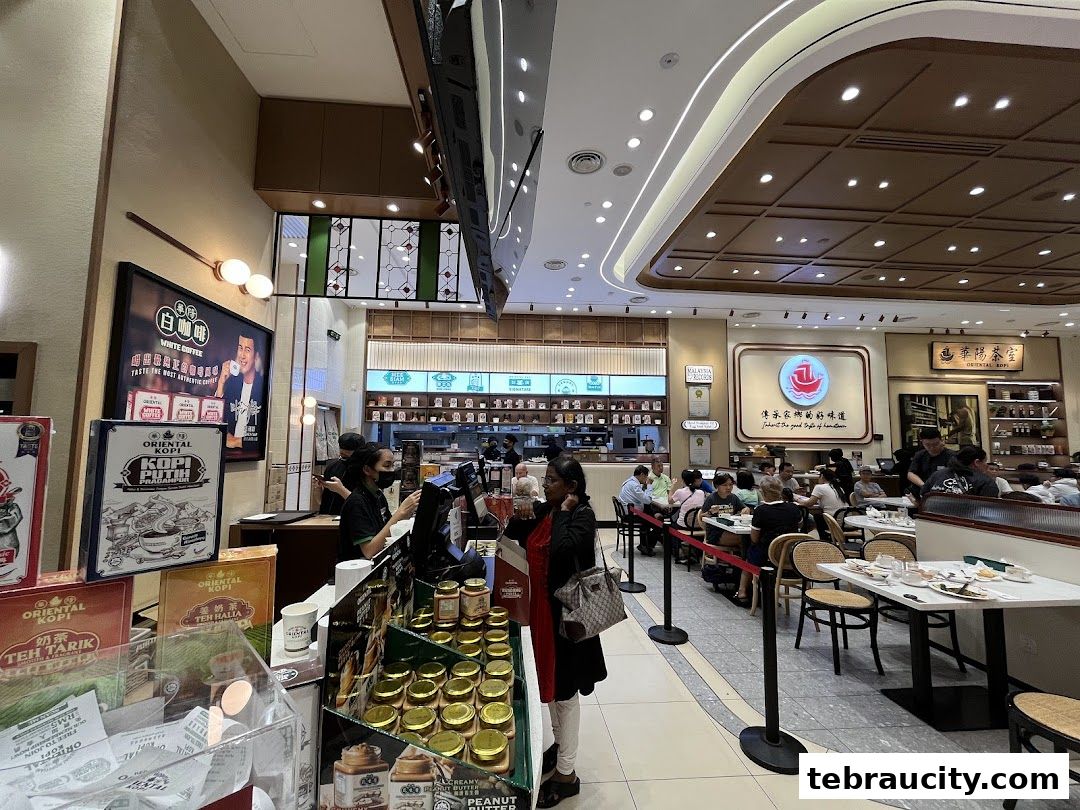 Interior view of Oriental Kopi restaurant with customers dining and products on display.