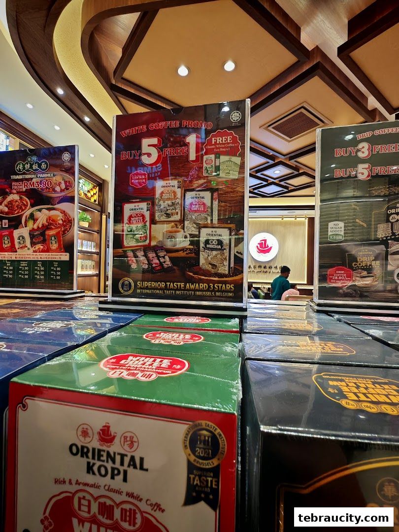 Promotional displays for Oriental Kopi white coffee and traditional noodles.