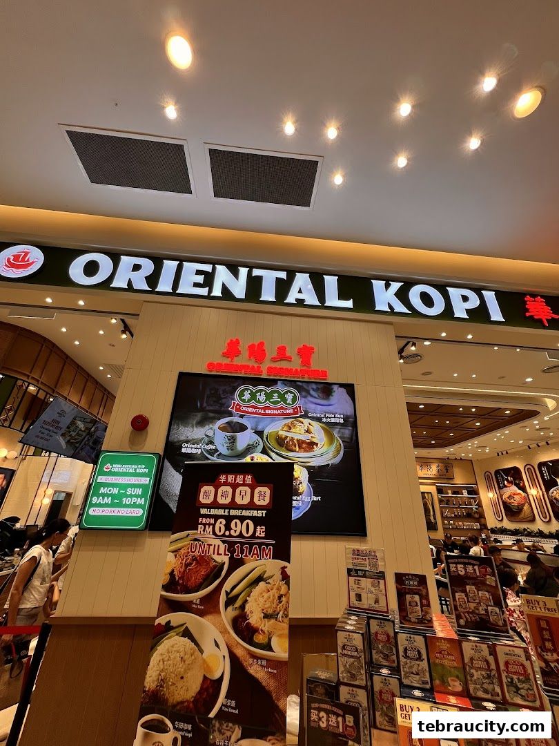 The exterior of Oriental Kopi, a cafe, with its prominent signage and promotional displays.