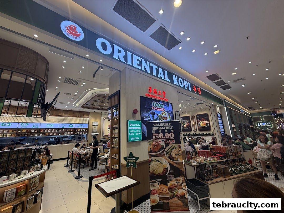 The entrance and interior of Oriental Kopi, a cafe with seating and displays of products.