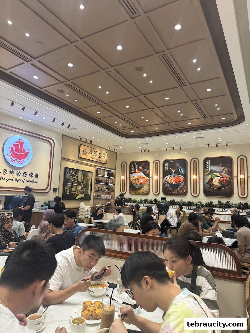 Diners enjoy meals at Oriental Kopi, with food art and branding visible.