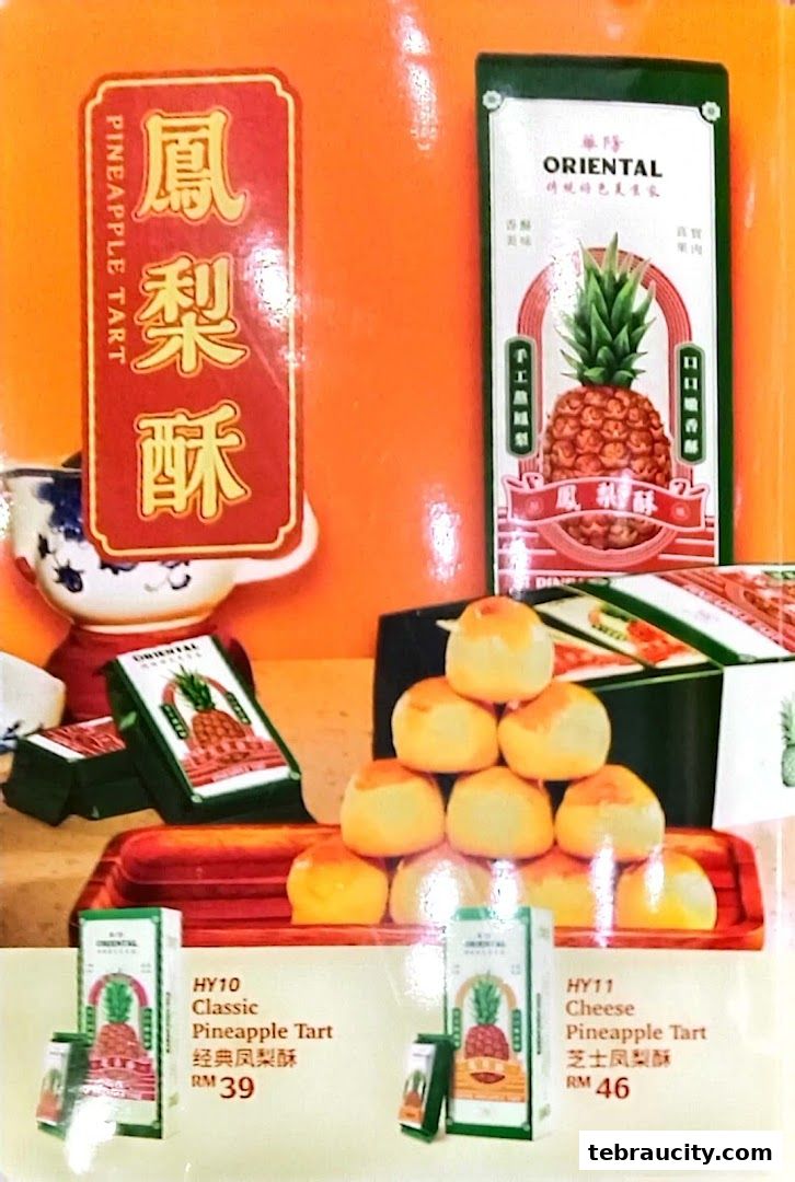 A display of Oriental Kopi pineapple tarts, featuring classic and cheese flavors with prices.