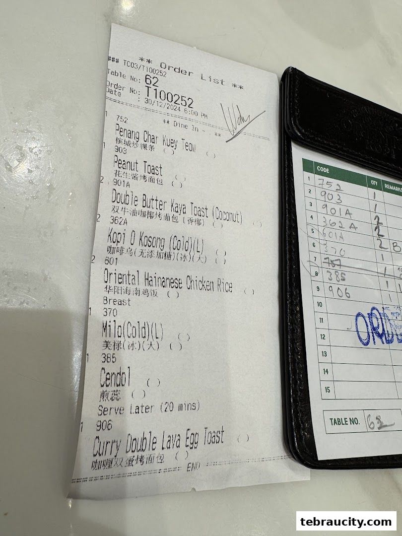 A close-up of a restaurant order slip and a bill holder with a table number.