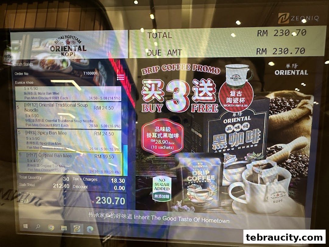 A computer screen displaying a bill and a coffee promotion for Oriental Kopi.