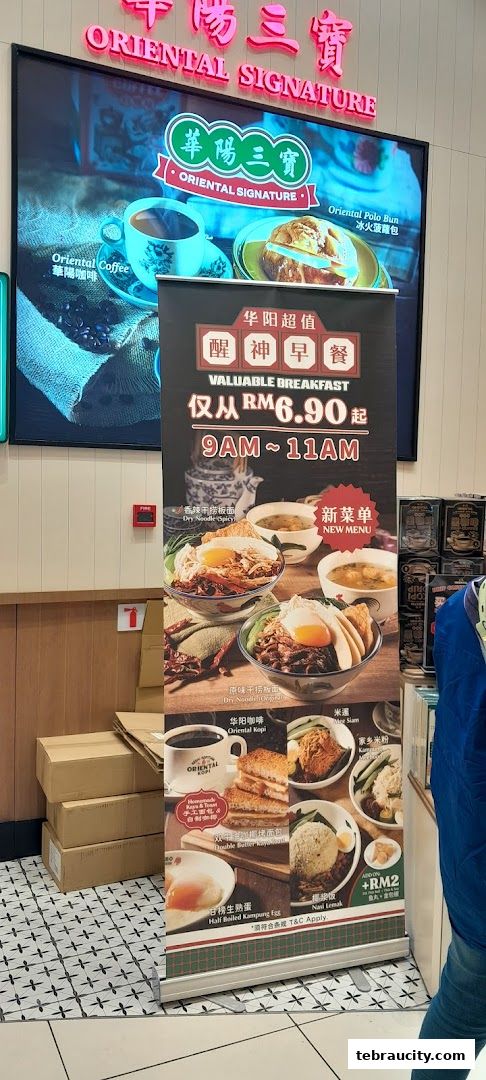 A promotional stand for Oriental Kopi featuring breakfast deals and menu items.