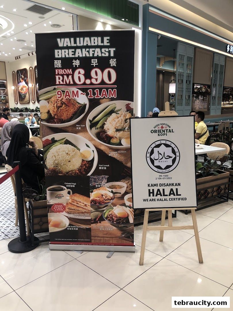 A breakfast promotion banner and a Halal certification sign for Oriental Kopi.