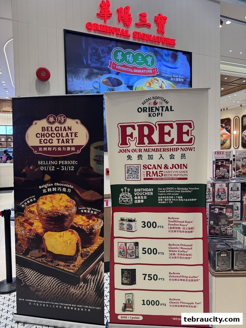 Two pull-up banners advertising Belgian Chocolate Egg Tarts and Oriental Kopi membership rewards.